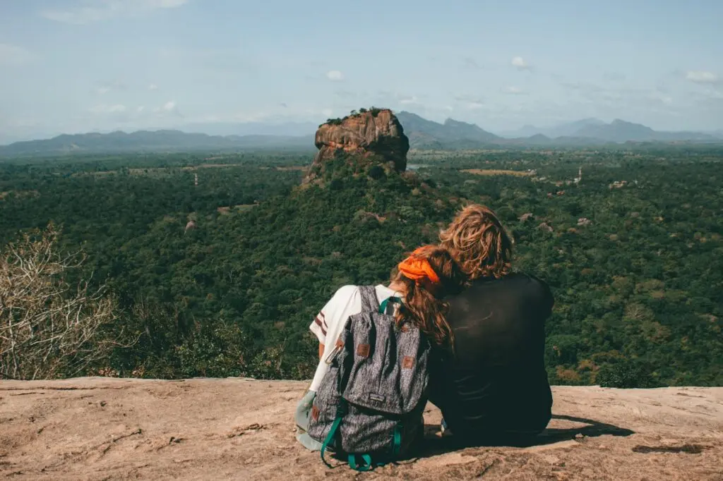 Man and woman sitting on a cliff
