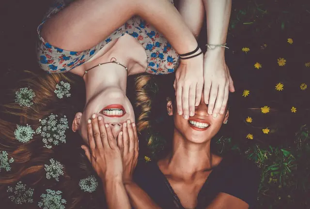 girls covering each others eyes