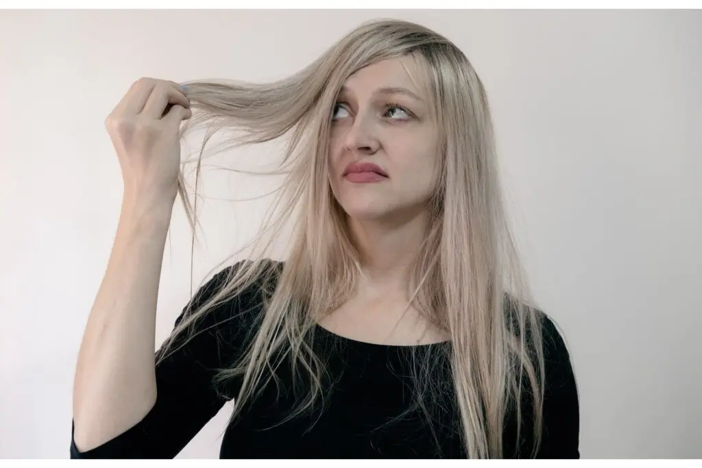 Woman holding up strands of her hair