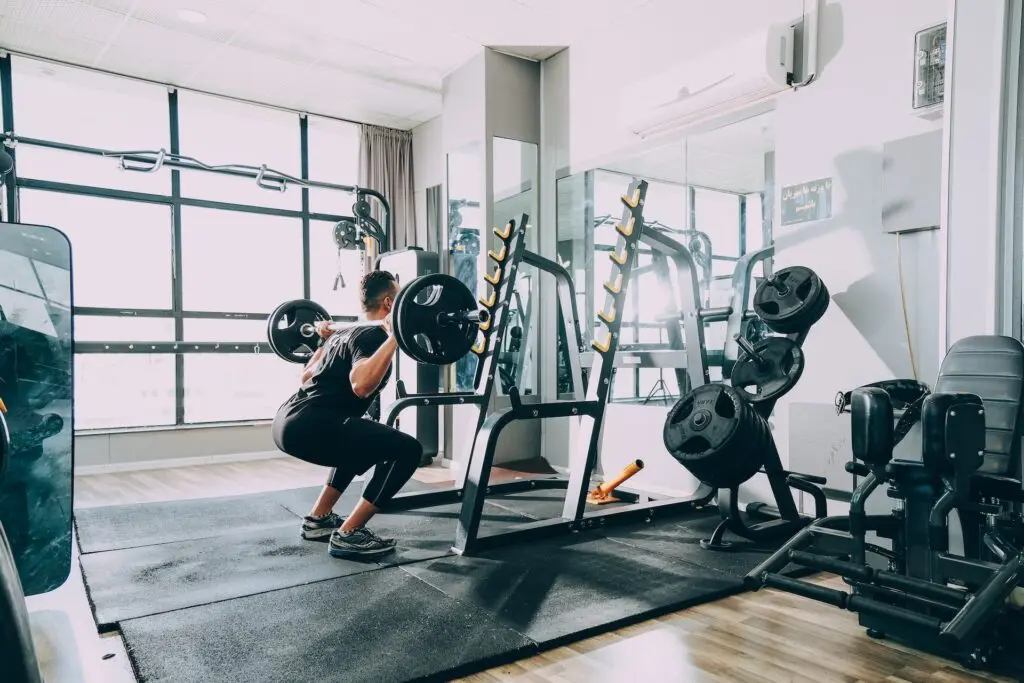 man doing squats with weights
