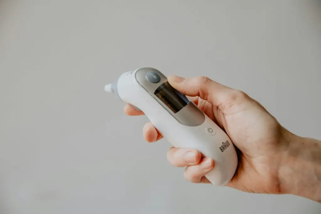 Thermometer being held.