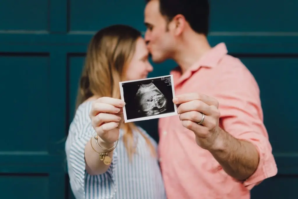Couple holding ultrasound photo
