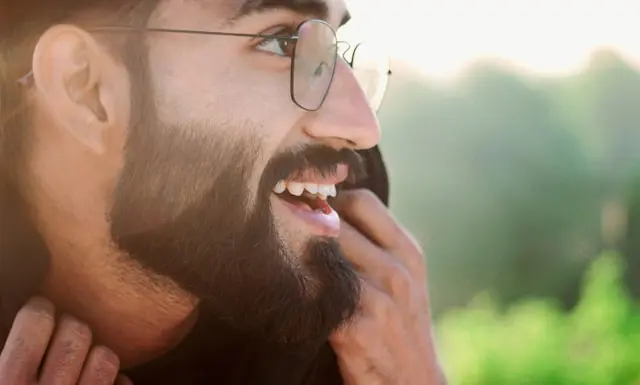 A man with a beard smiling