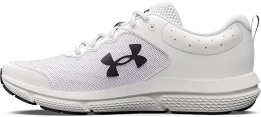 A pair of white Under Armour tennis shoes with black soles and a black logo sit against a white background.