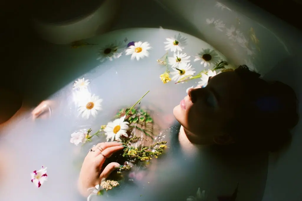 Woman Soaking in a Milk Bath With Flowers