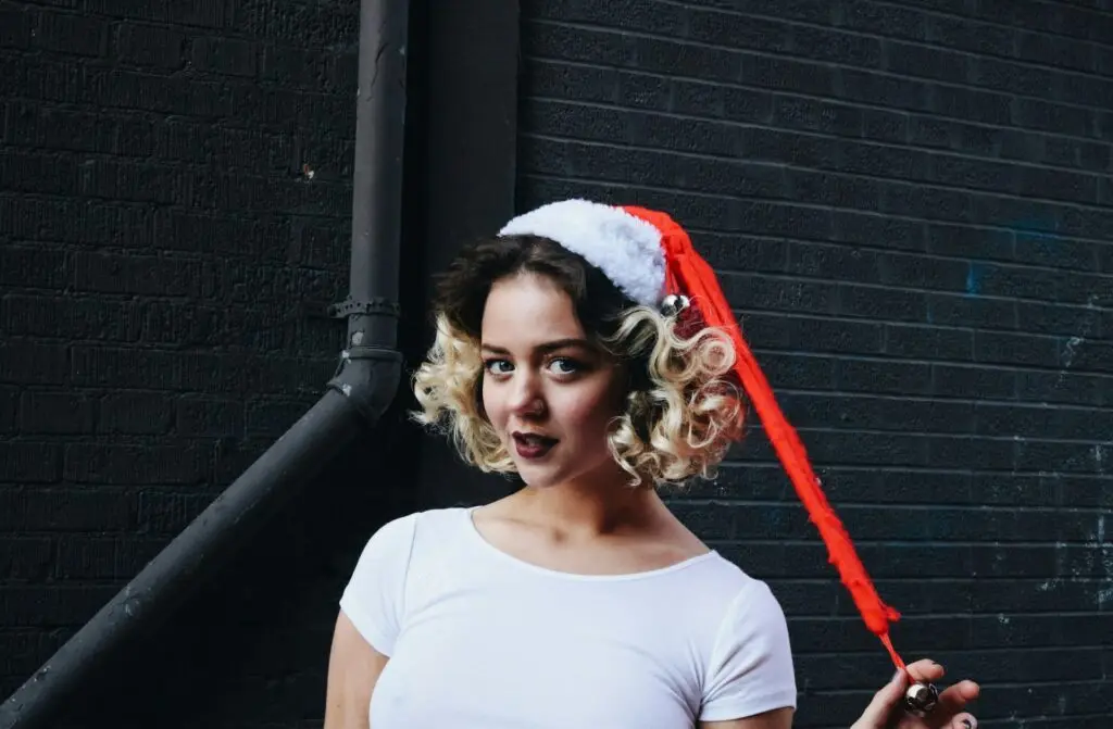 A girl wearing a Santa cap with curls