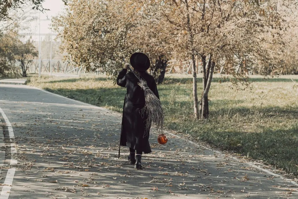 Person in Witch Costume Walking Down a Path
