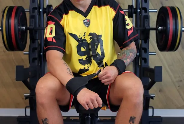 A lifter wearing wrist straps