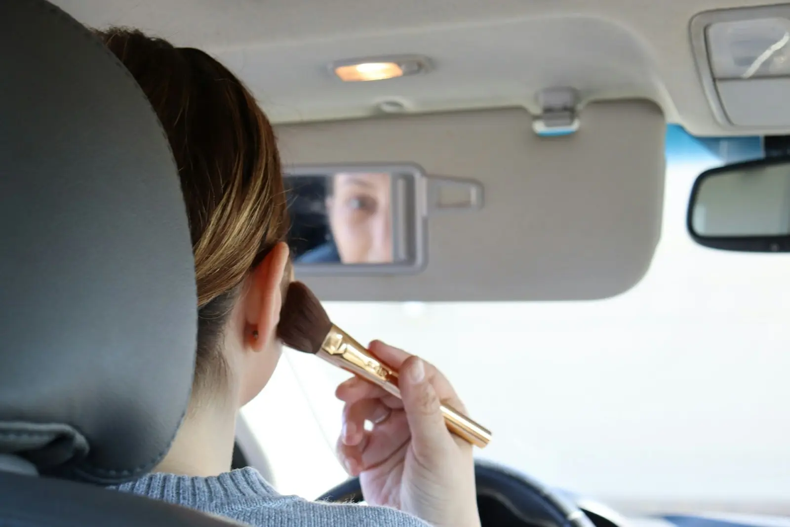 applying makeup in the car