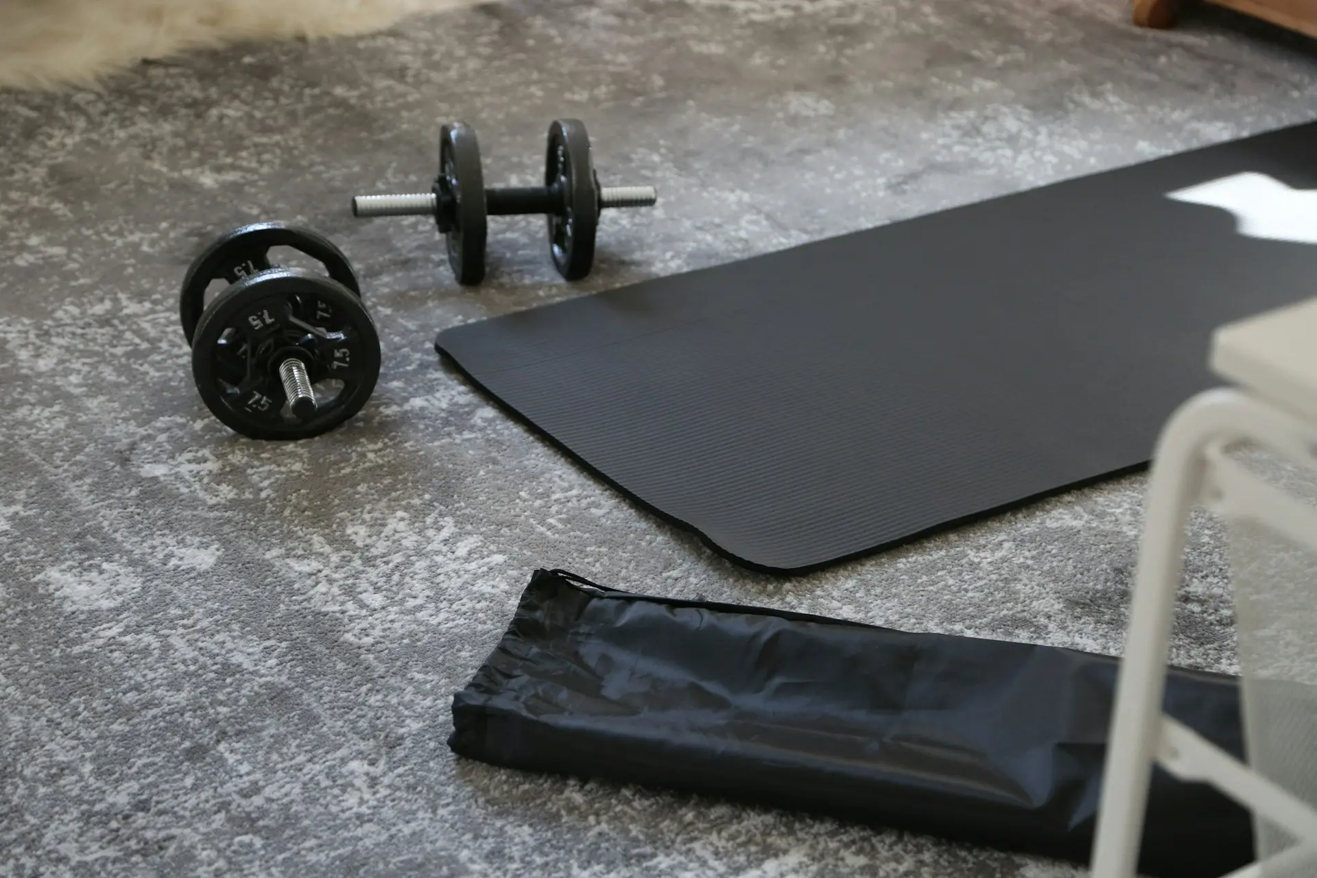 Mat and dumbbells for exercising before bedtime.