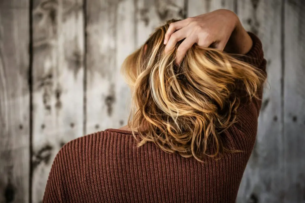 A woman tousling her hair