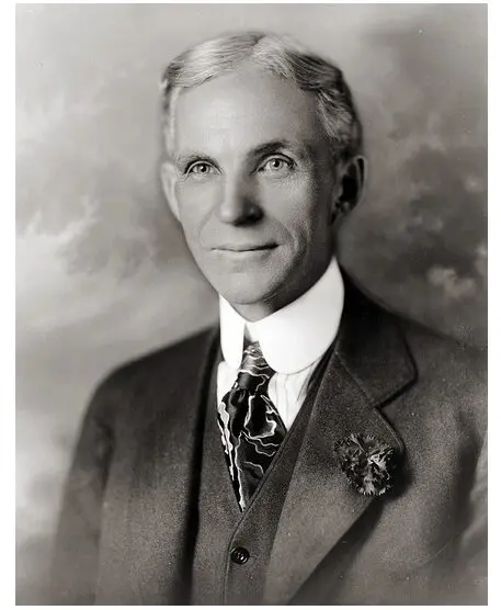 A black and white photo of Henry Ford wearing a suit and tie.