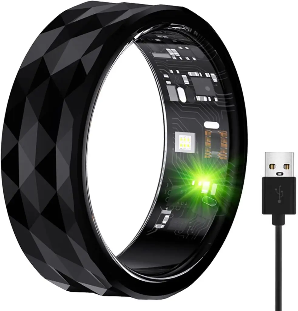 A black metal HitTopss ring with geometric rows sits against a white background. The USB end of its charging cord sits to its right.