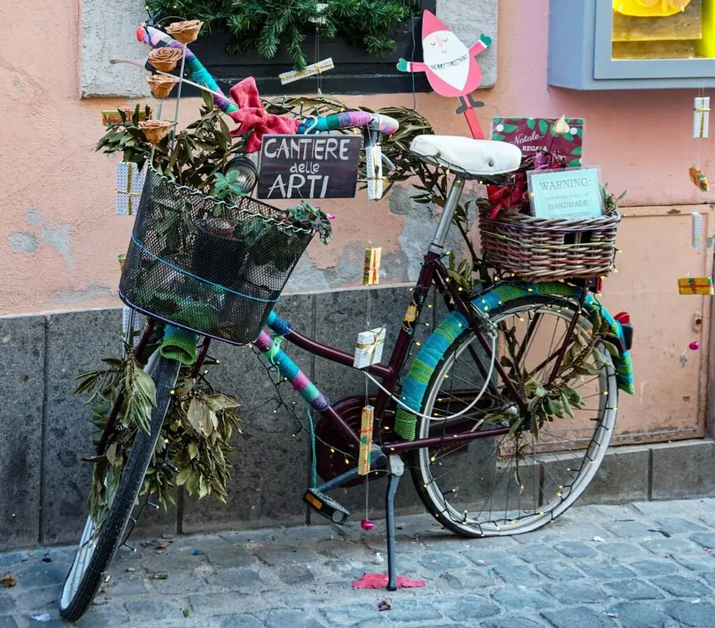 A burr basket on the back of a bike strewn with Christmas lights