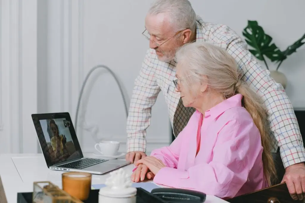 A young woman speaking with her elderly parents