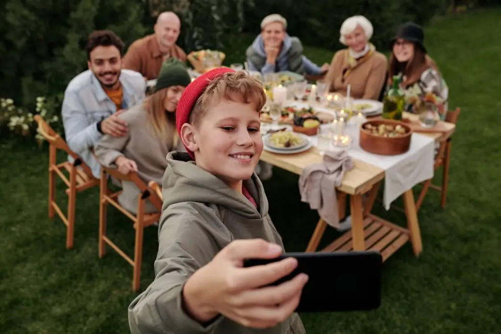 A large family enjoying a dinner together and taking a photo