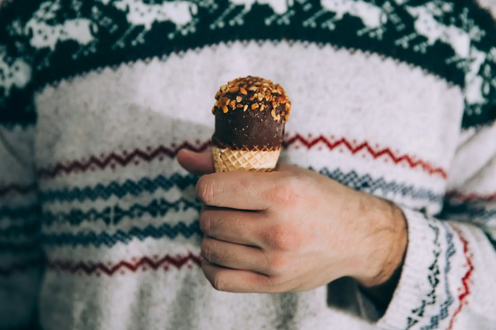 christmas sweater and holding ice cream