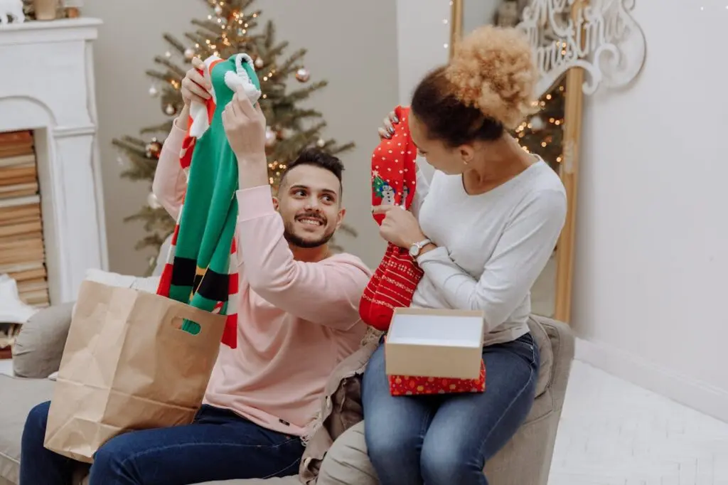 A couple openings Christmas presents together