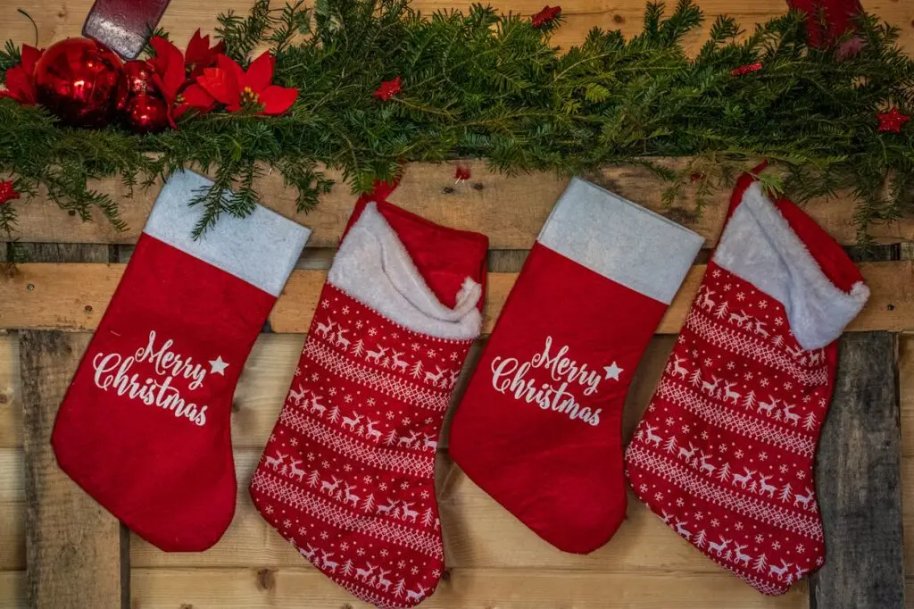 Four red stockings hanging on a wall