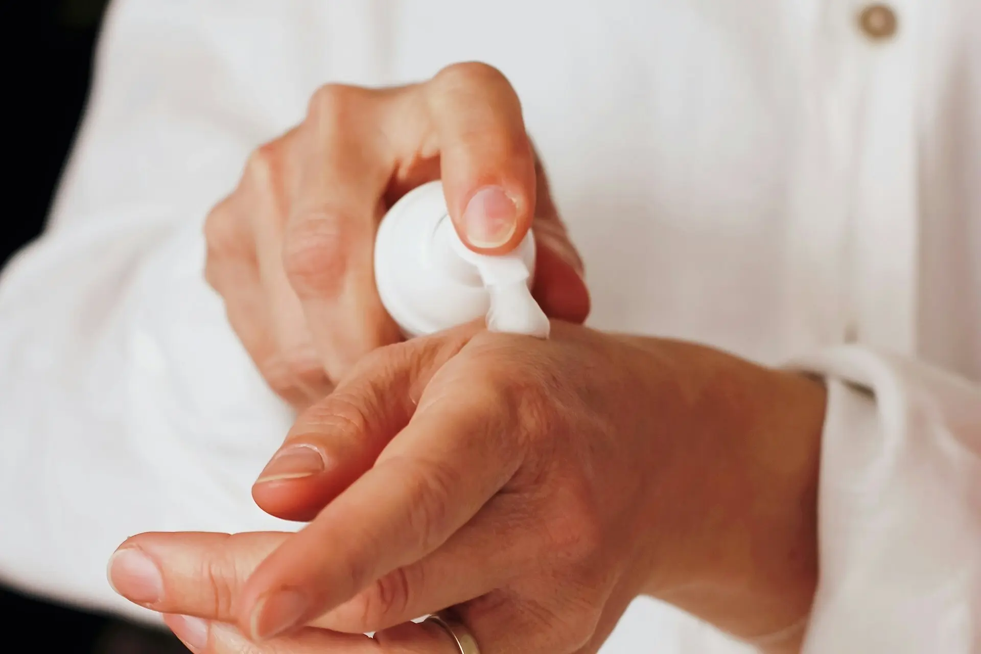 applying lotion to tanned hands