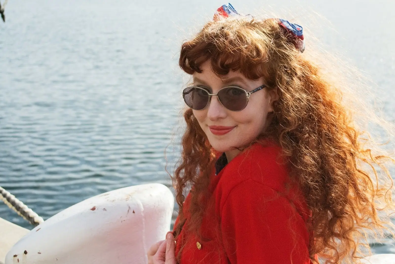 curly haired woman on a boat