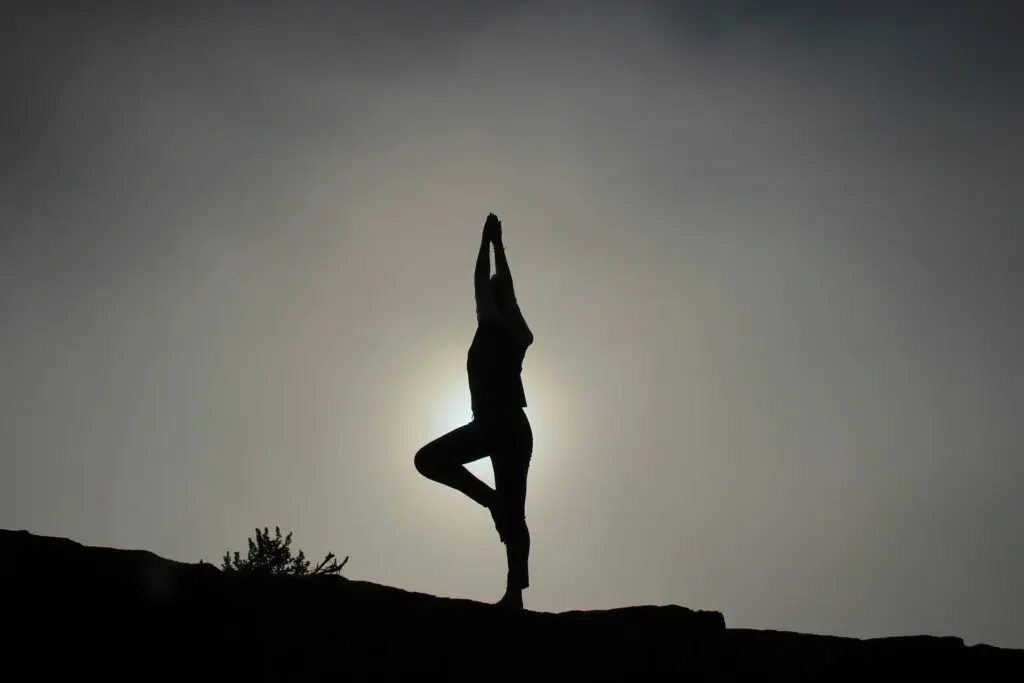 A woman practicing yoga for better posture.