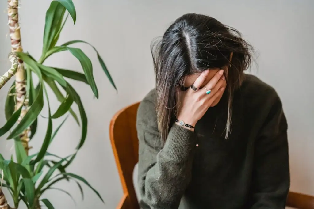 A stressed woman with her head in her hand