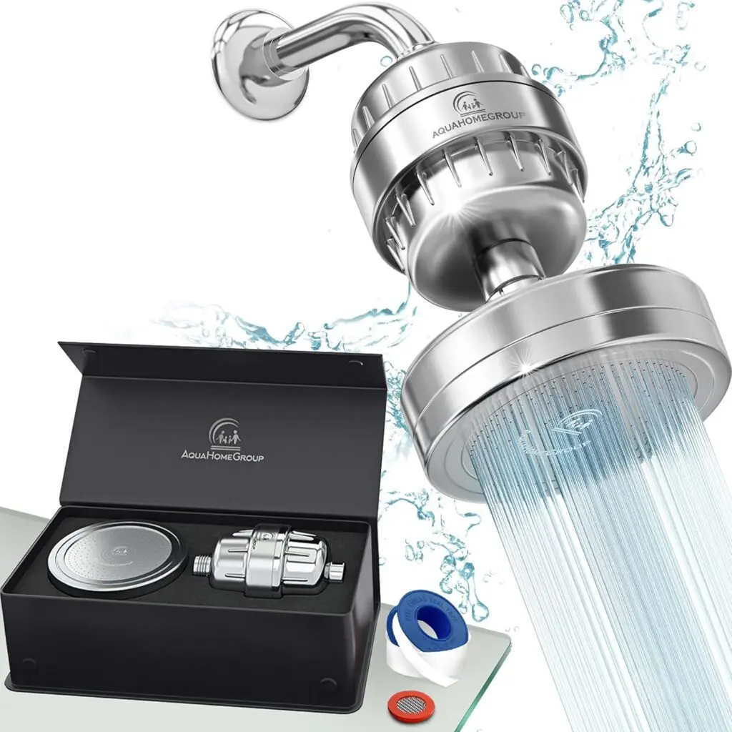 The AquaHomeGroup's water filter shower head sits against a white background. Its black packaging sits on a counter in the bottom left corner.