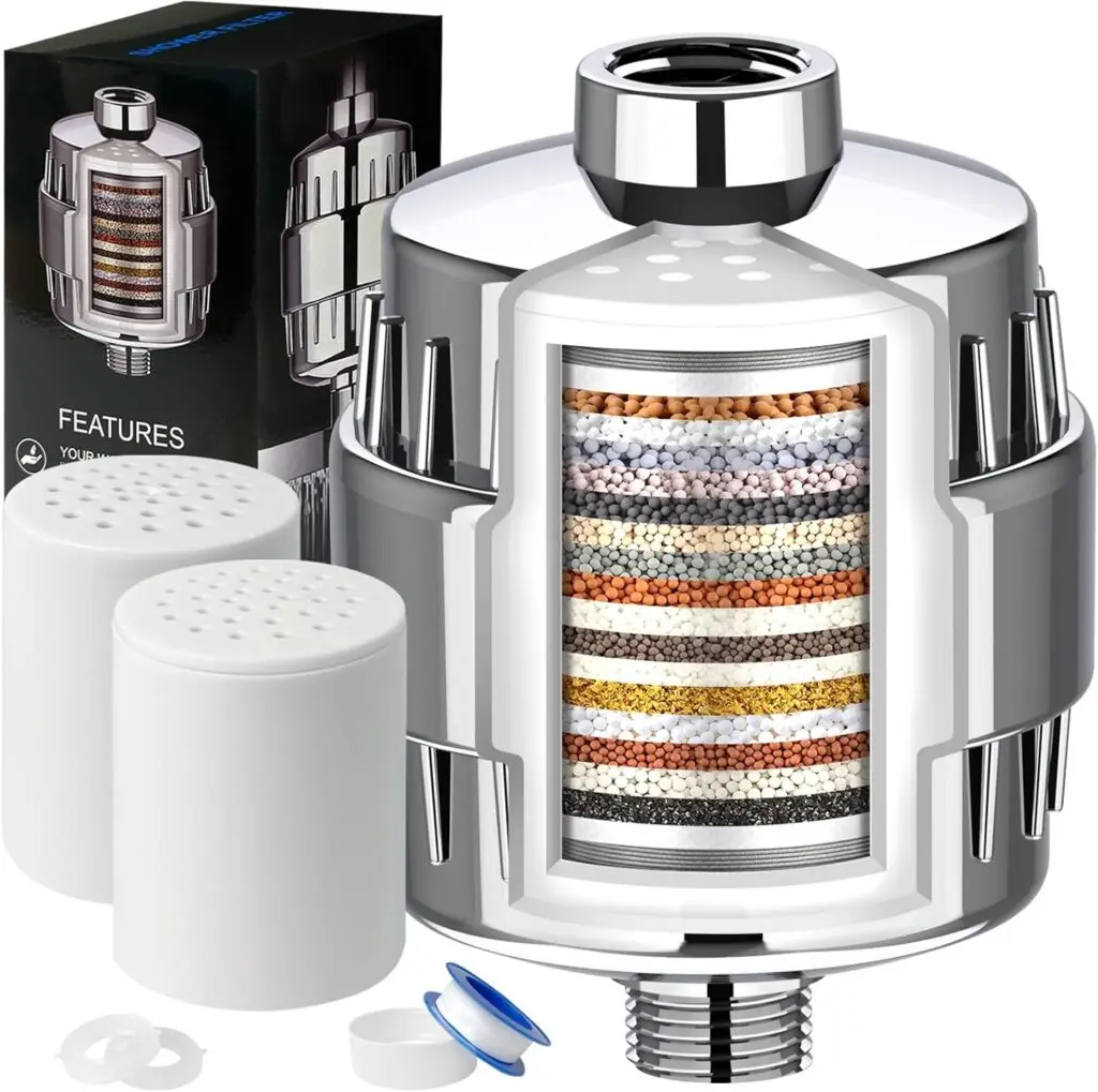 Dwavele's 20-stage water filter sits against a white background. It sits next to two replacement cartridges and its black packaging. It's one of the best options for anyone looking for a shower filter for clear skin.