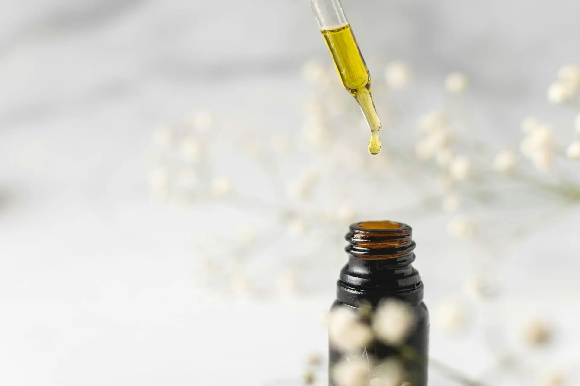 A bottle of castor oil with a glass dropper