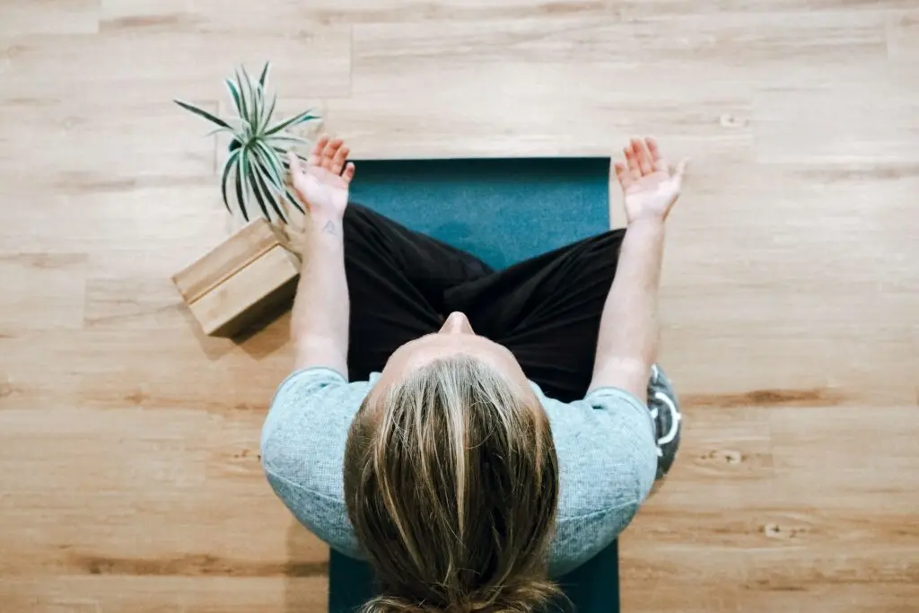 Woman meditating on yoga mat