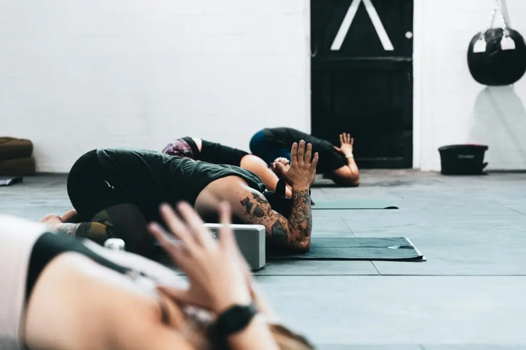 People doing Child's Pose on yoga mat