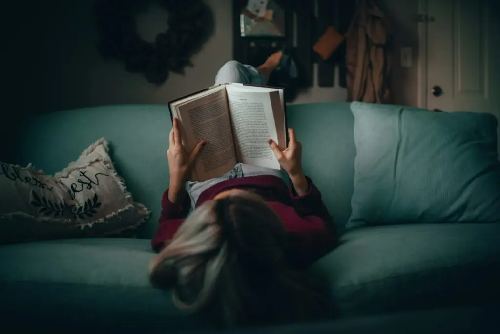 A girl reading as part of the 75 Hard Challenge.