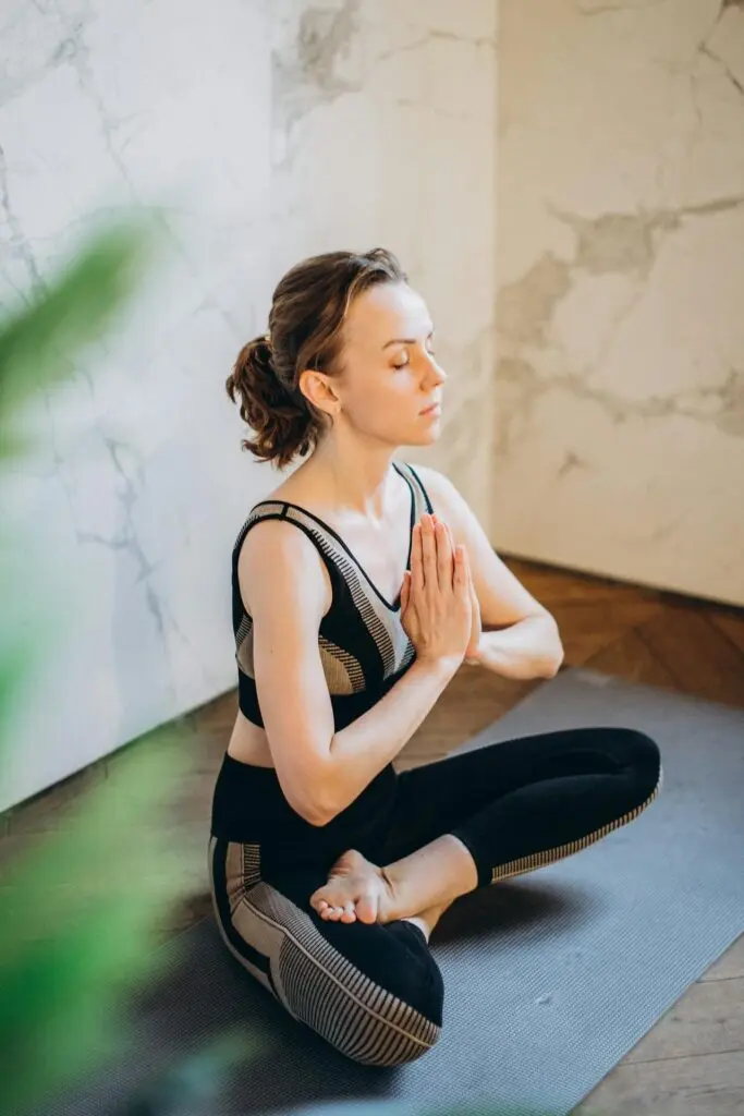 A woman sitting in a yoga pose