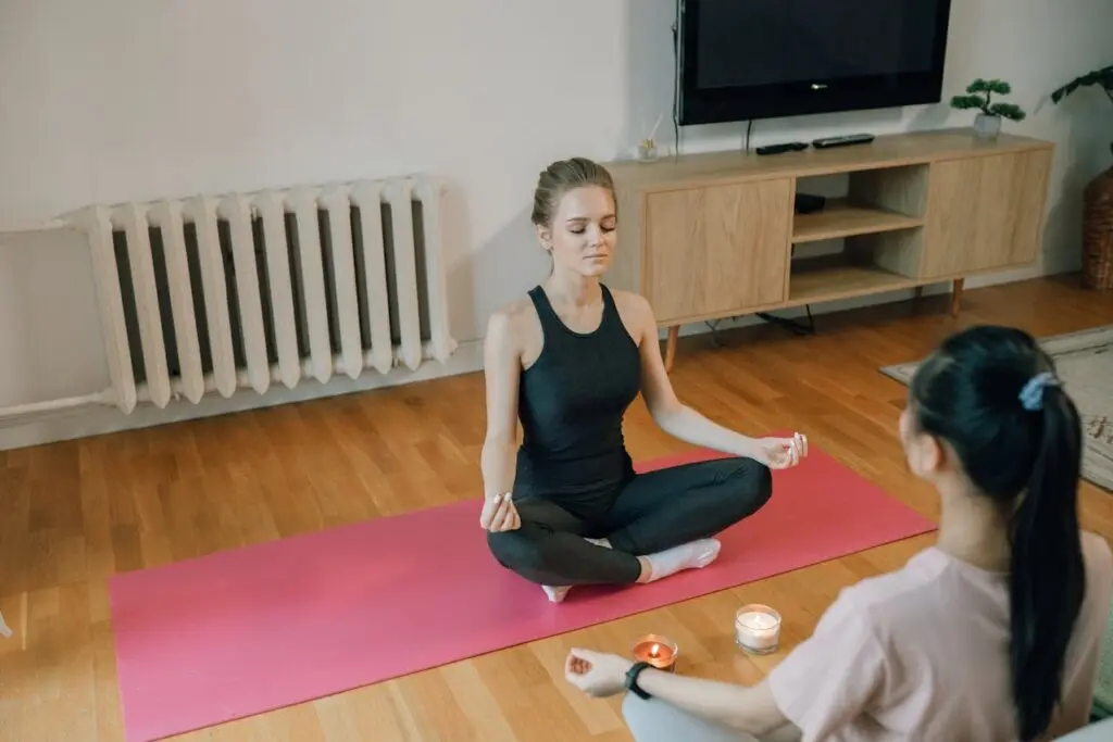 Two women engaging in breathwork and meditation