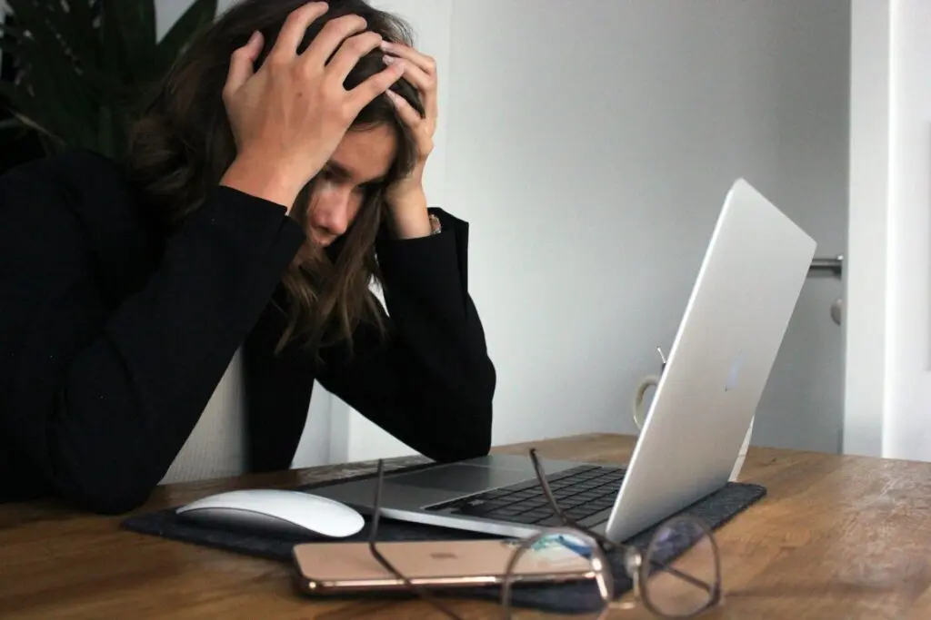 A woman feeling stressed over her work-life balance.