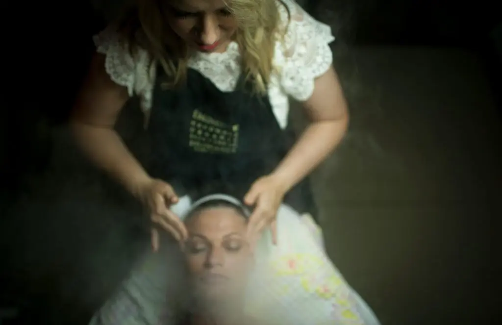 A person receiving a steam facial