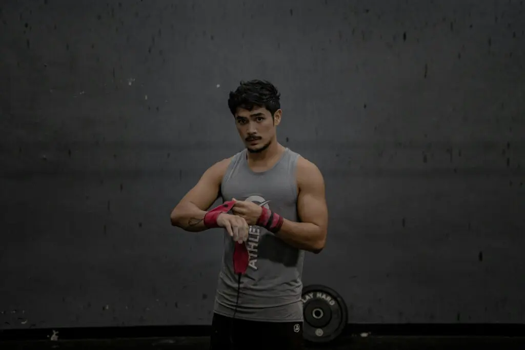 A man strapping his wrists before working out