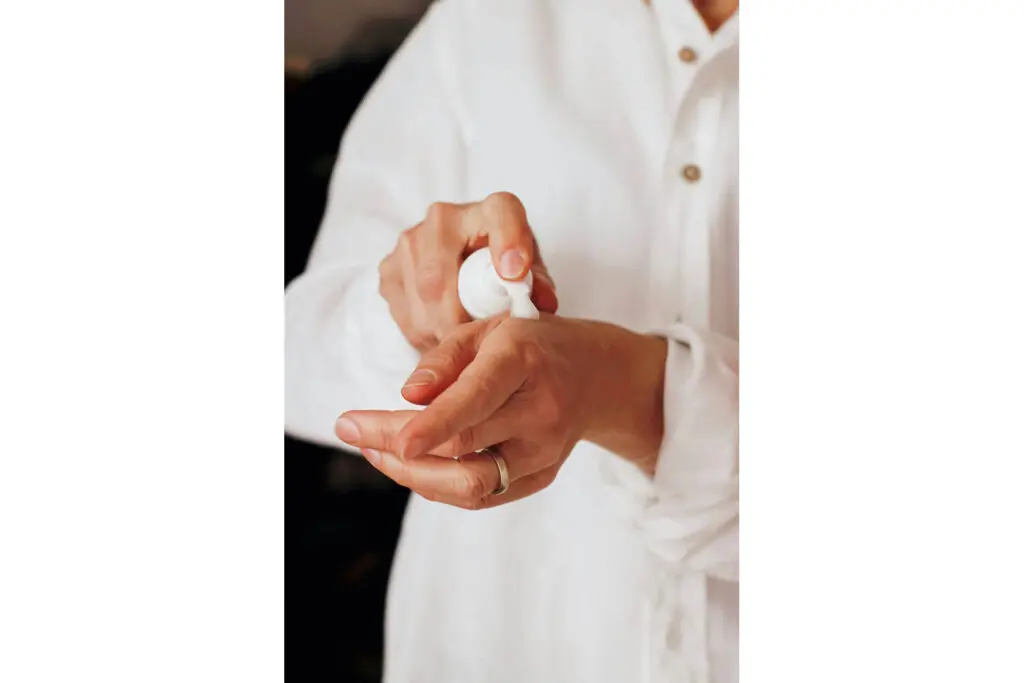 A person using a mousse formula skincare product on their hand