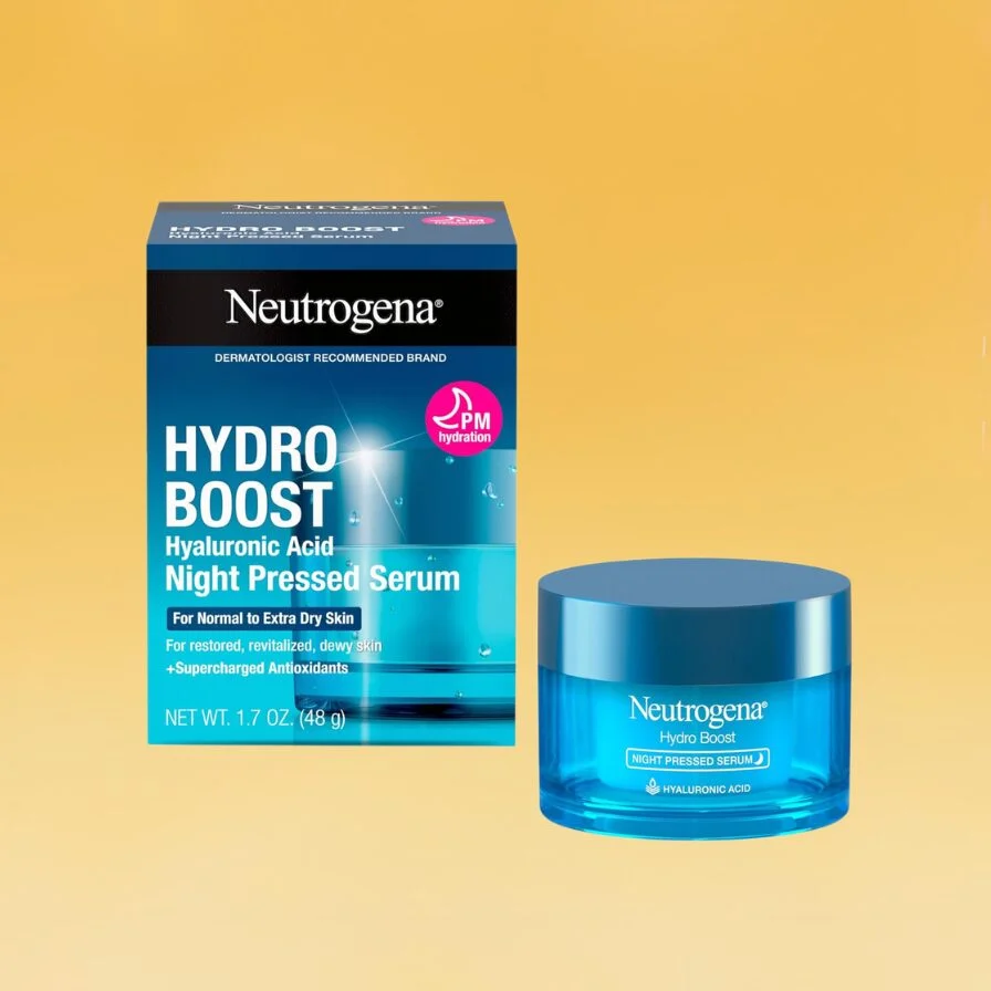 A blue box of Neutrogena's Hydro Boost Hyaluronic Acid Night Pressed Serum and a blue glass jar of the product sits against the yellow Body+Mind background.
