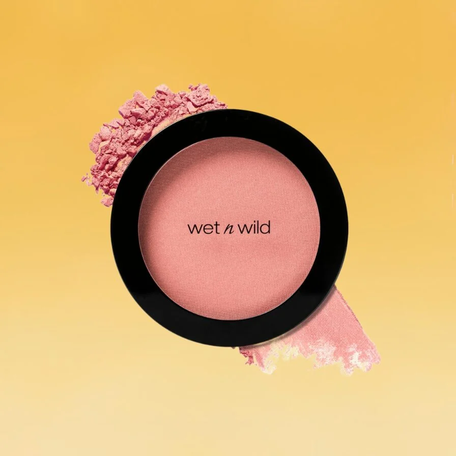 A clear and black container of wet n wild's Icon blush sits against the yellow Body+Mind background.