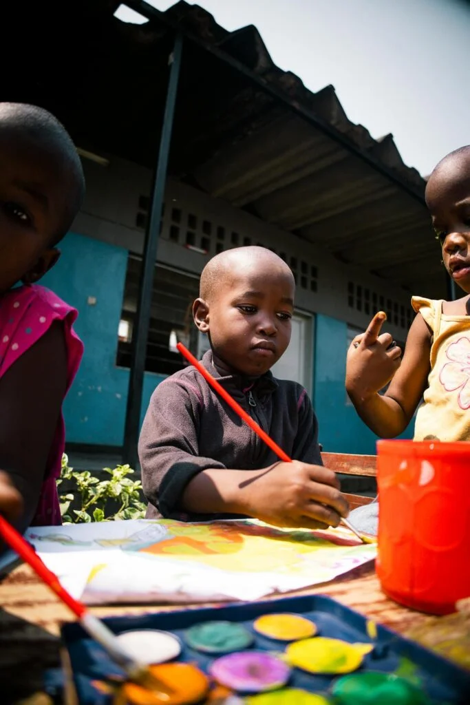 Children Painting Outdoors in Warm Sunlight