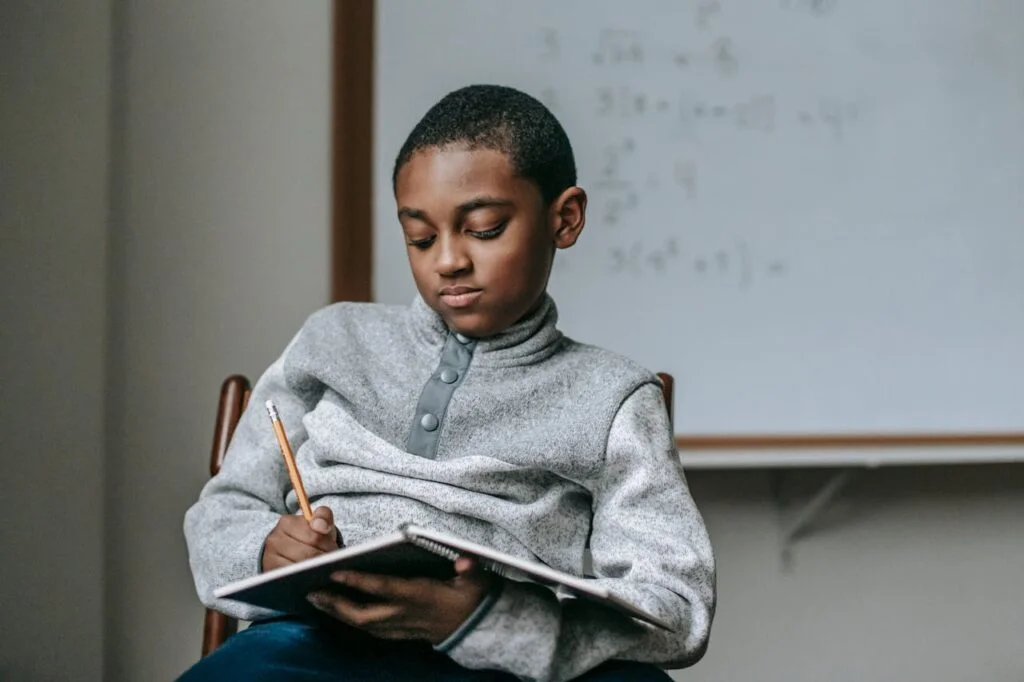 kid doing task in copybook