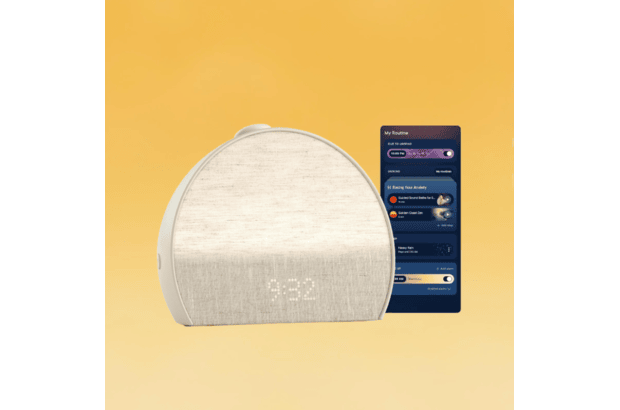 A Hatch Restore 3 sunrise alarm clock with a mobile device next to it