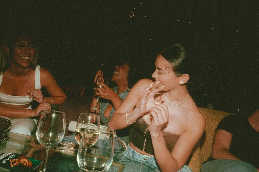 A group of young women sitting around a table enjoying each other's company