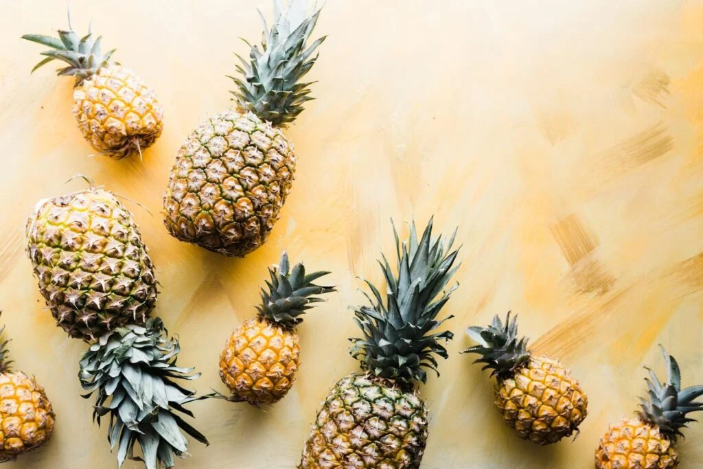 various pineapples on yellow surface