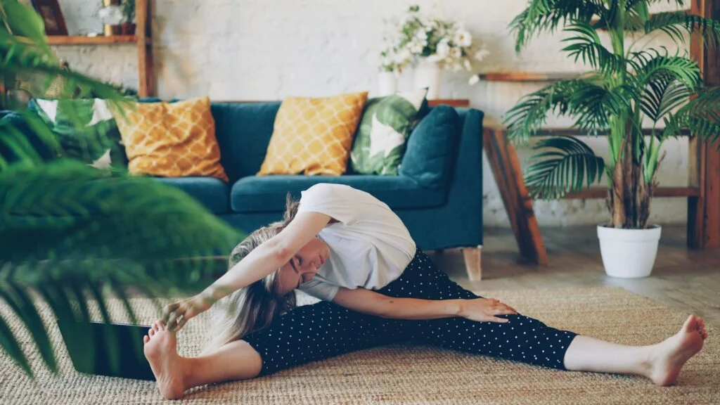 Woman stretching on floor in a living room