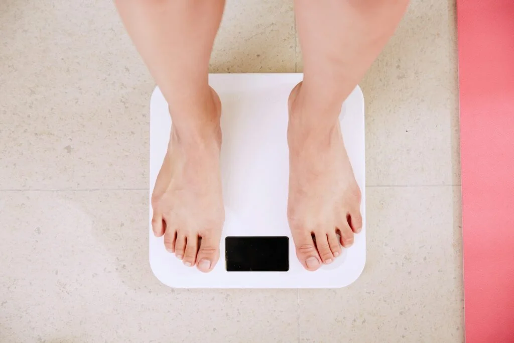 A person standing on a scale.