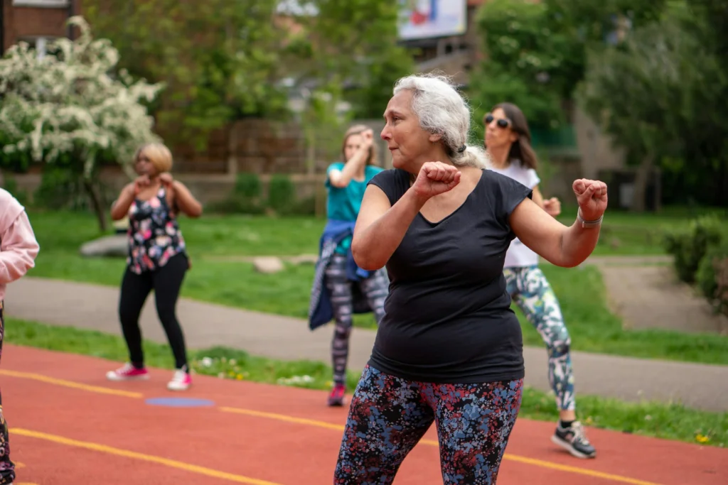 a group of older people on a track doing exercises