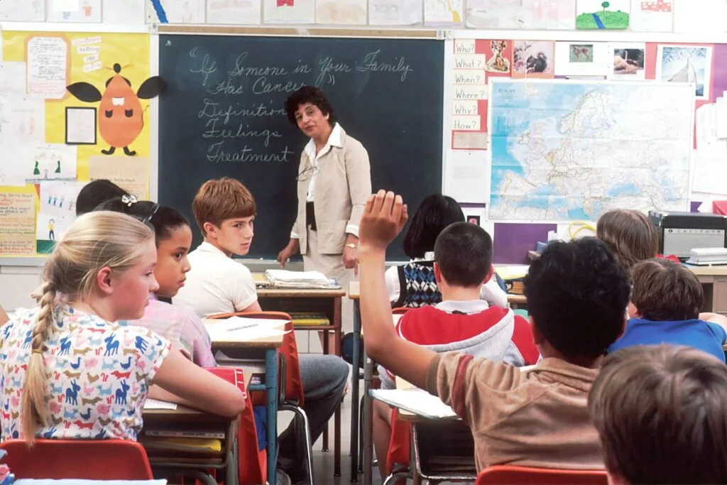 Female teacher standing in front of students in a classroom